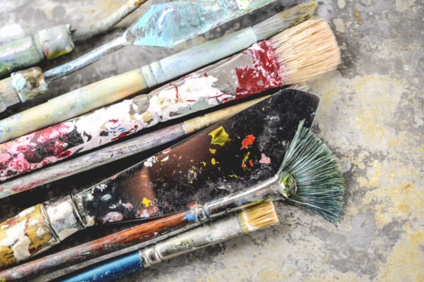 Dirty paint brushes on aluminum tray (Shallow DOF)